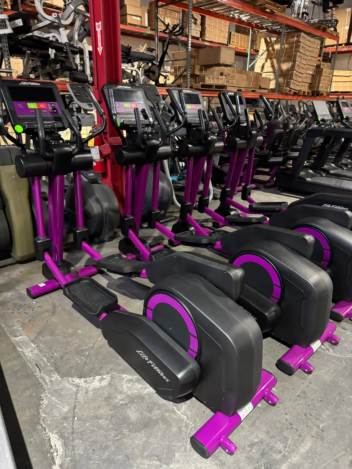 Pre-owned Life Fitness Integrity elliptical with C Console and current purple overlay — angled view